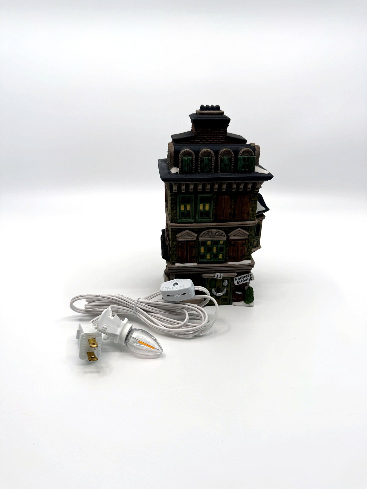 The Flat of Ebenezer Scrooge with its new replacement light cord and bulb (enhanced)