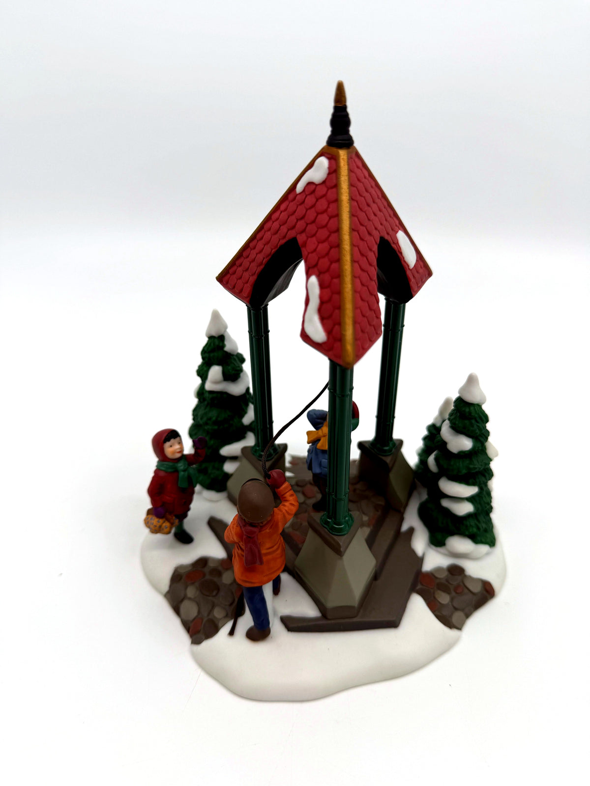 Department 56 Christmas Bells, 1996 Special Event Piece, Heritage Village Collection – front three-quarter view: red-shingled bell pavilion, brass bell, three children, snowy evergreens
