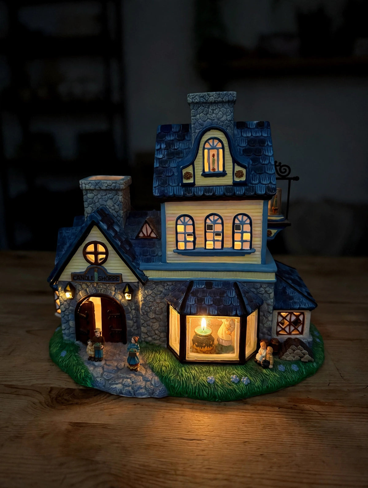 PartyLite Olde World Village No. 1 The Candle Shoppe P7315 ceramic tealight village building — styled scene: lit by tealights at dusk, windows glowing (display inspiration)