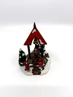 Department 56 Christmas Bells, 1996 Special Event Piece, Heritage Village Collection – angled view with evergreens