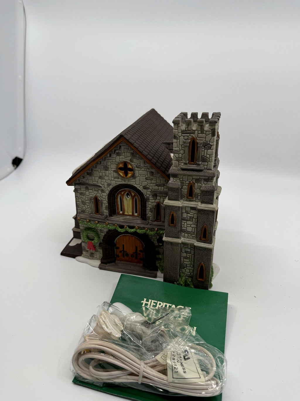 Whittlesbourne Church with its light cord in the packaging and Heritage Village booklet (enhanced)