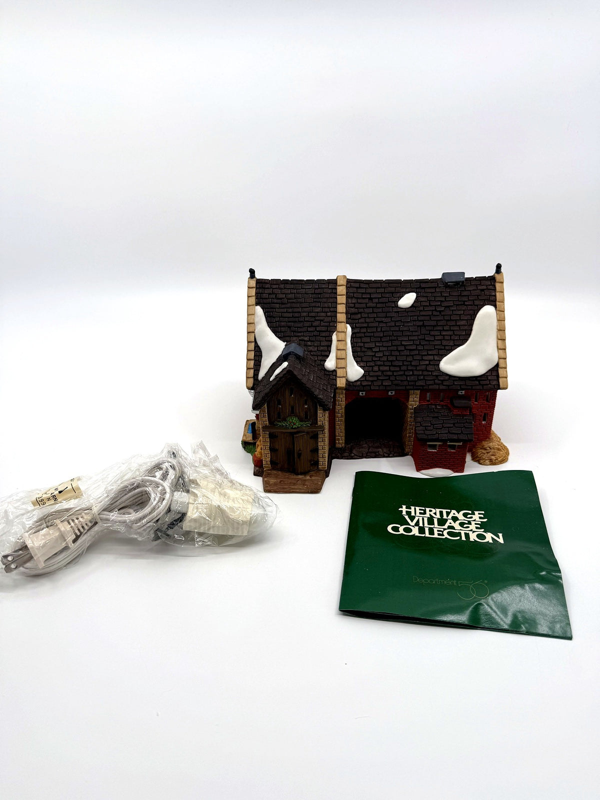 Department 56 Dickens' Village Butter Tub Barn #58338 – the building with its original light cord still sealed in packaging and the Heritage Village Collection literature booklet