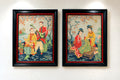 Styled wall view of both vintage framed Asian figural textile artworks together