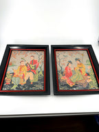 Vintage Asian figural textile art — signed framed pair — the pair side by side, front view on a shelf stand
