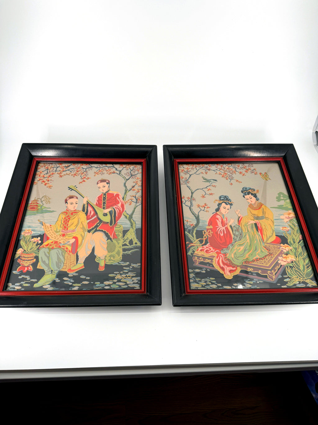 Vintage Asian figural textile art — signed framed pair — the pair, front view