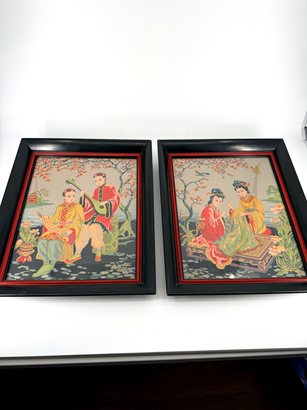 Vintage Asian figural textile art — signed framed pair — the pair, front view