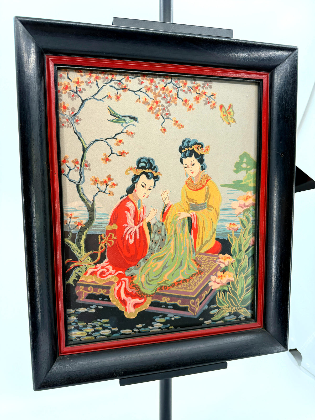 Vintage Asian figural textile art — signed framed pair — the two-women panel at an angle, closer view