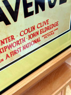 Angled close-up detail of poster credits and frame edge