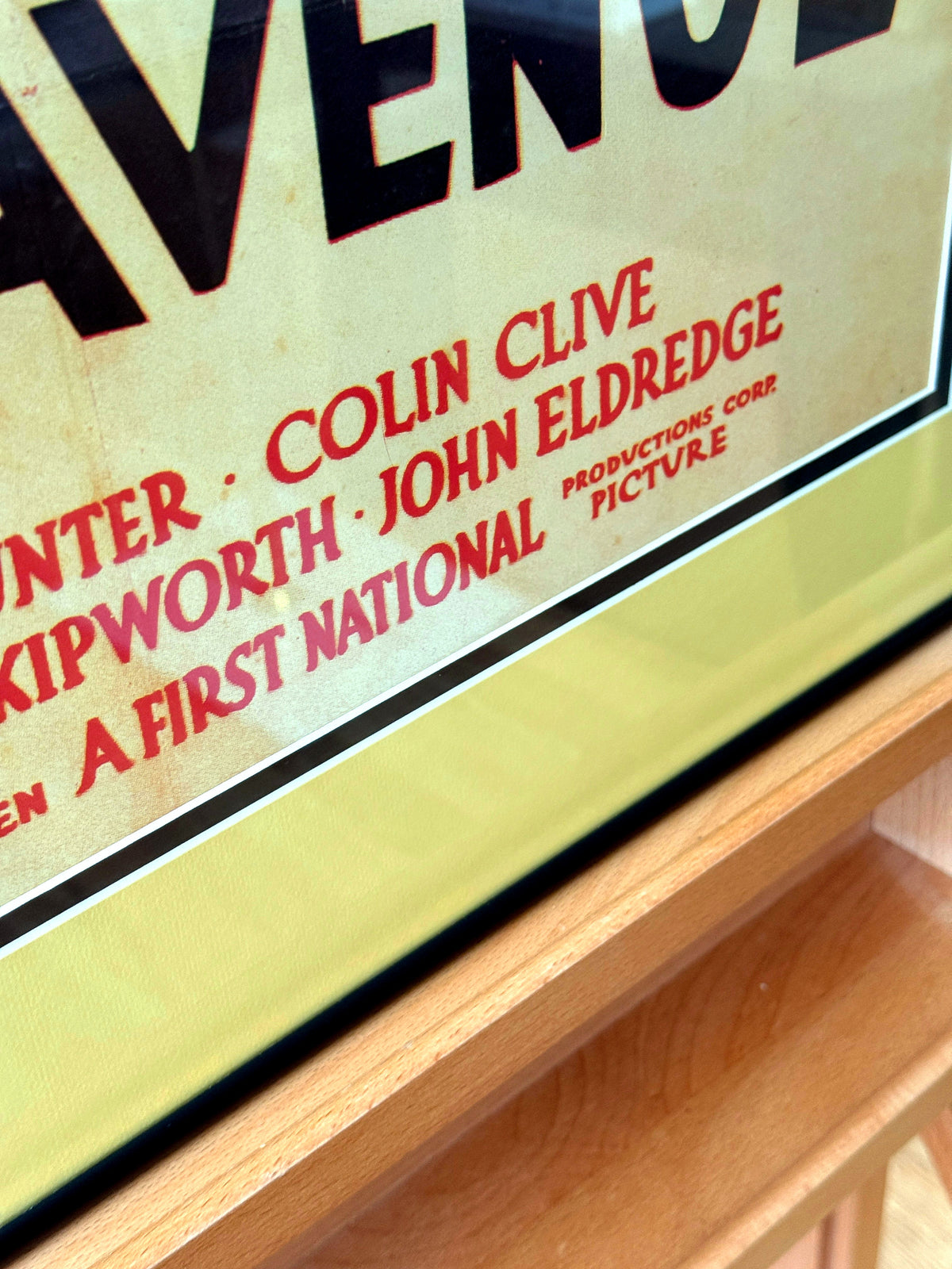 Angled close-up detail of poster credits and frame edge