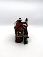 Front three-quarter view showing the half-timbered gable and snow-dusted red tile roof