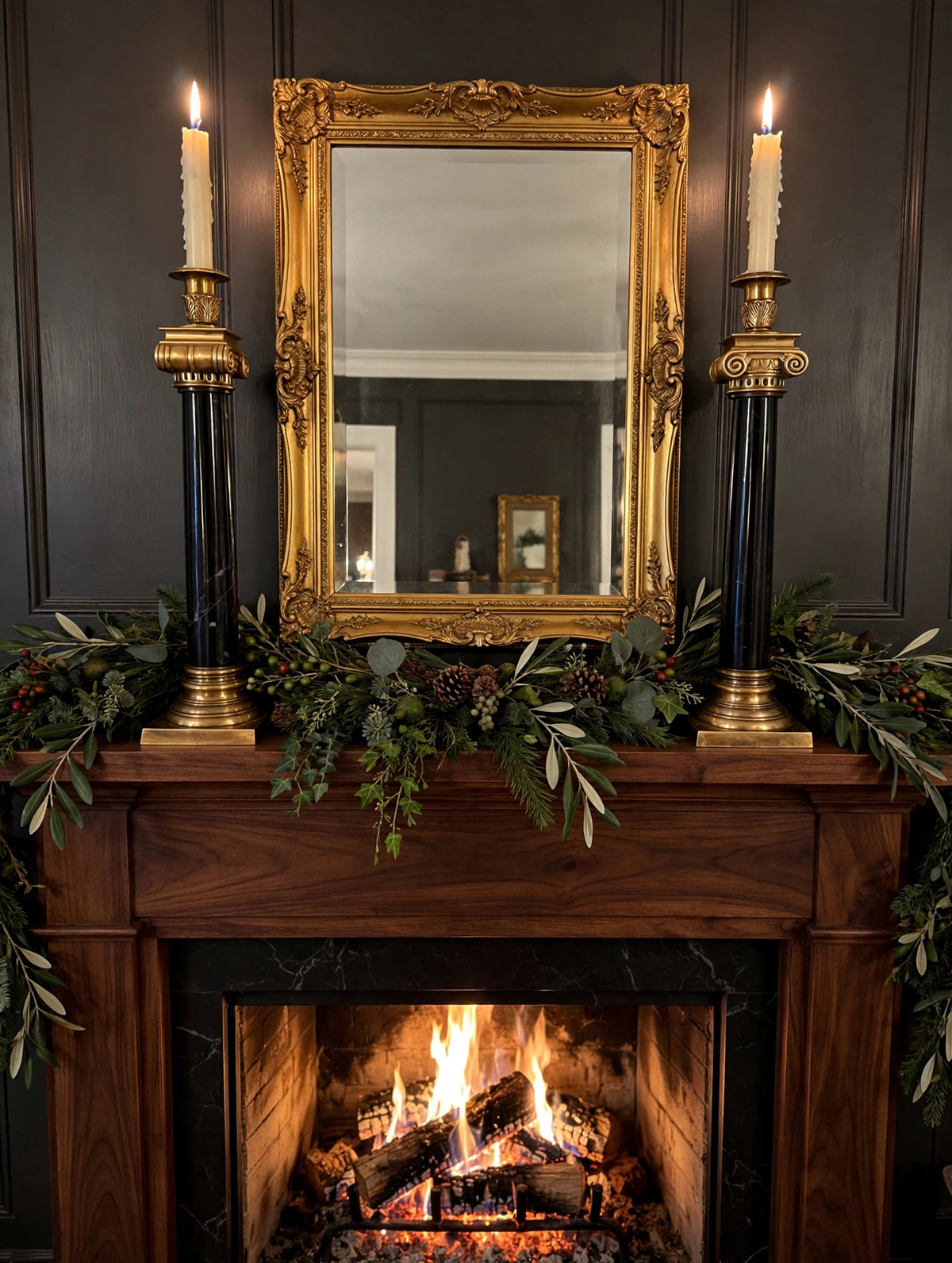 Styled lifestyle photo — the brass and black marble candlesticks (14.5 in) with lit tapers on a fireplace mantel (display inspiration)