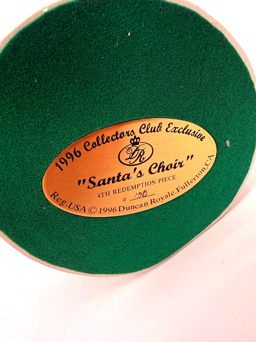 Underside: gold identification label on green felt, 1996 Collectors Club Exclusive, Santa's Choir, 4th Redemption Piece No. 100 (enhanced)