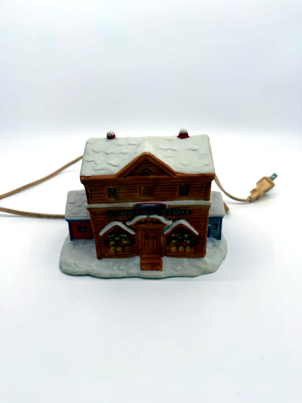 Lighted ceramic Christmas village country store, straight front view with cord and plug