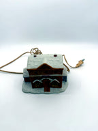 Lighted ceramic Christmas village country store, front view from above showing the snow-covered roof