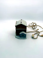 Lighted ceramic Christmas village country store, left side view with gray-blue annex