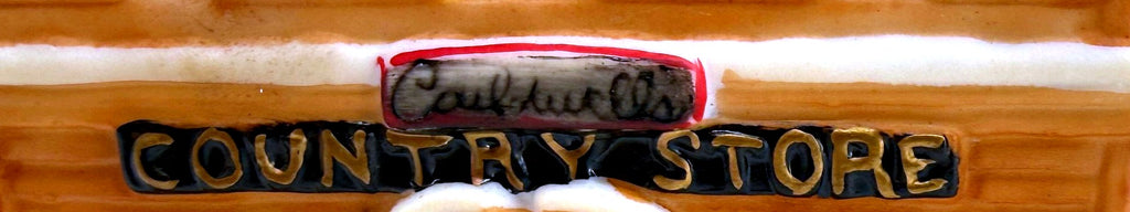 Close-up of the COUNTRY STORE sign and hand-lettered nameplate