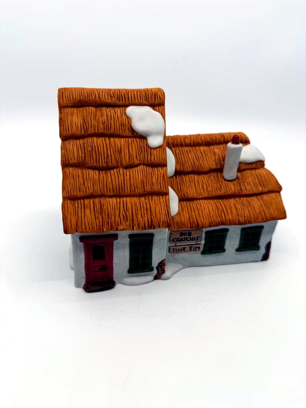 Front three-quarter view showing the tall thatched gable and the lower wing