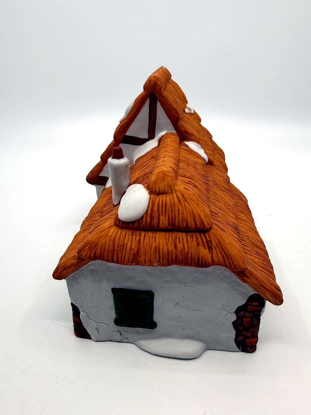 Right gable end with half-timbering and green attic window
