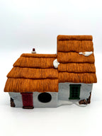 Back view with the red plank door and round lighting cord opening