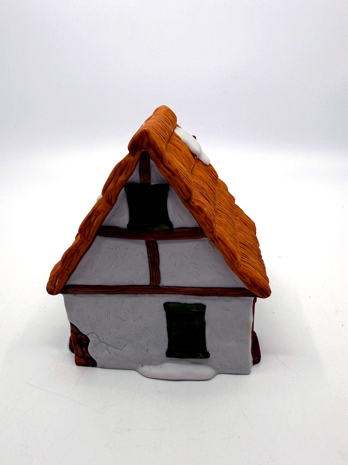 Left end with half-timbered gable, green windows and exposed stone corners