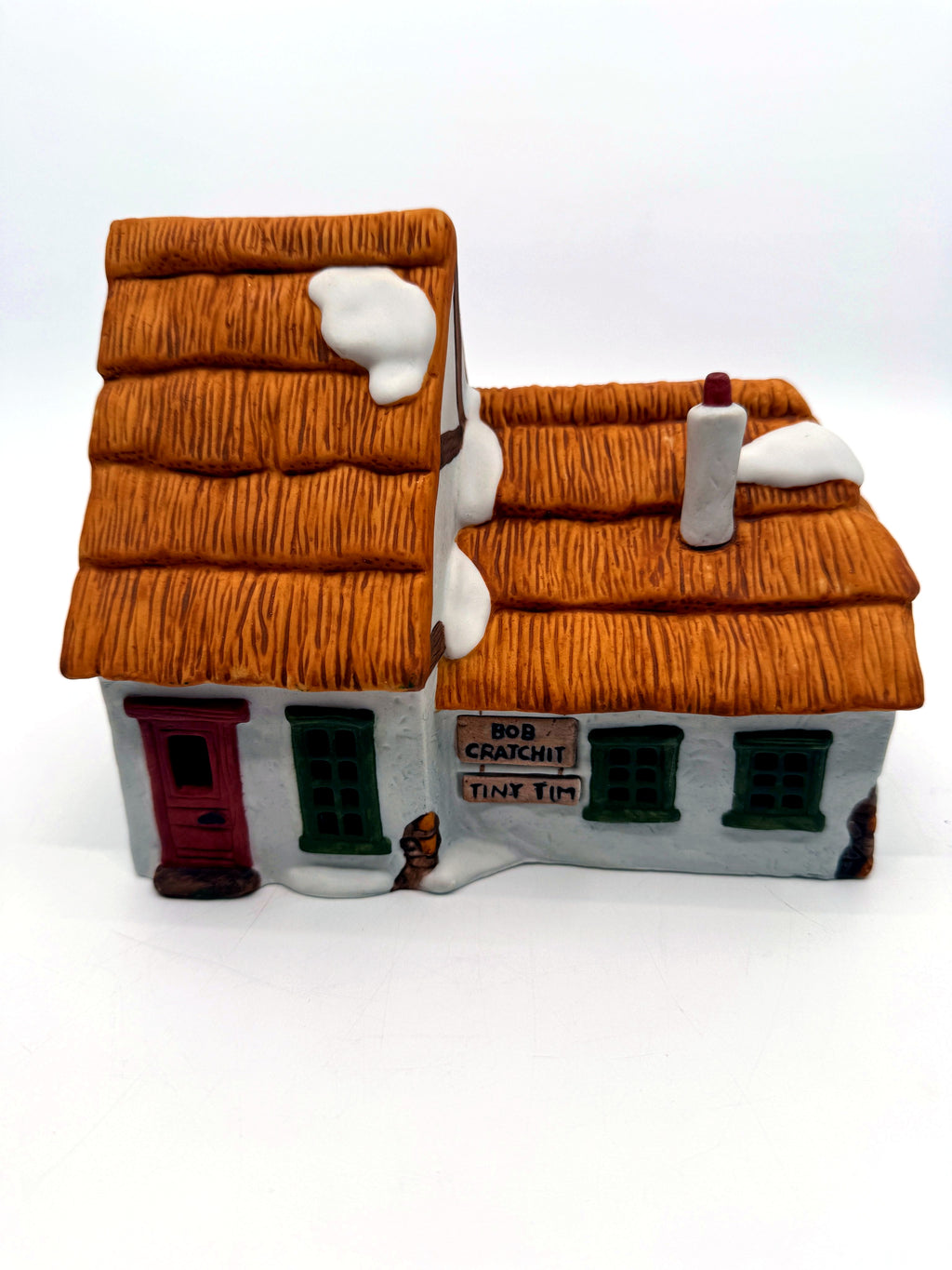 Front view, closer: red door, green windows and the Bob Cratchit and Tiny Tim plaques