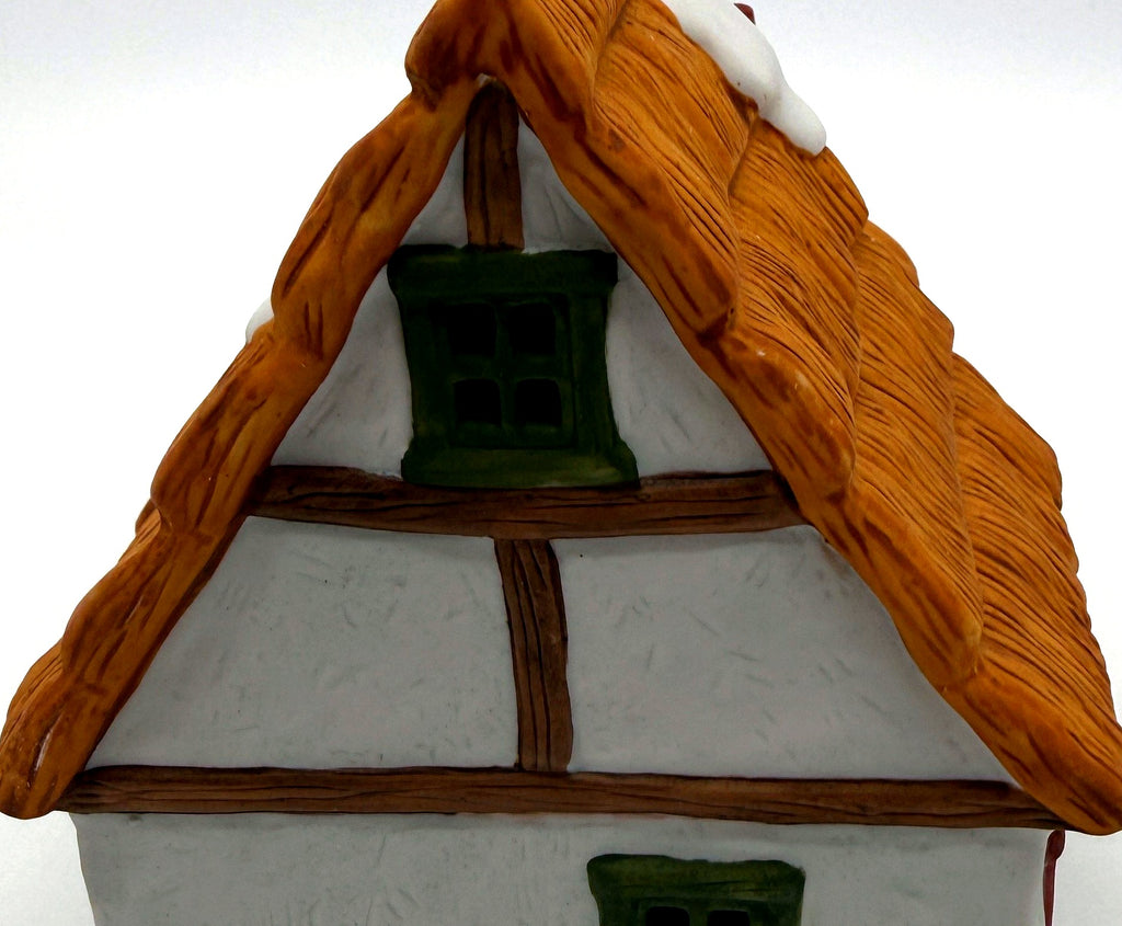 Detail of the half-timbered gable end with green attic window
