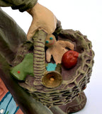 Detail: woven basket of gifts with gingerbread man, brass horn and apple (detail from seller photo)