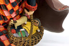 Detail: woven basket with toy rocking horse and doll (detail from seller photo)