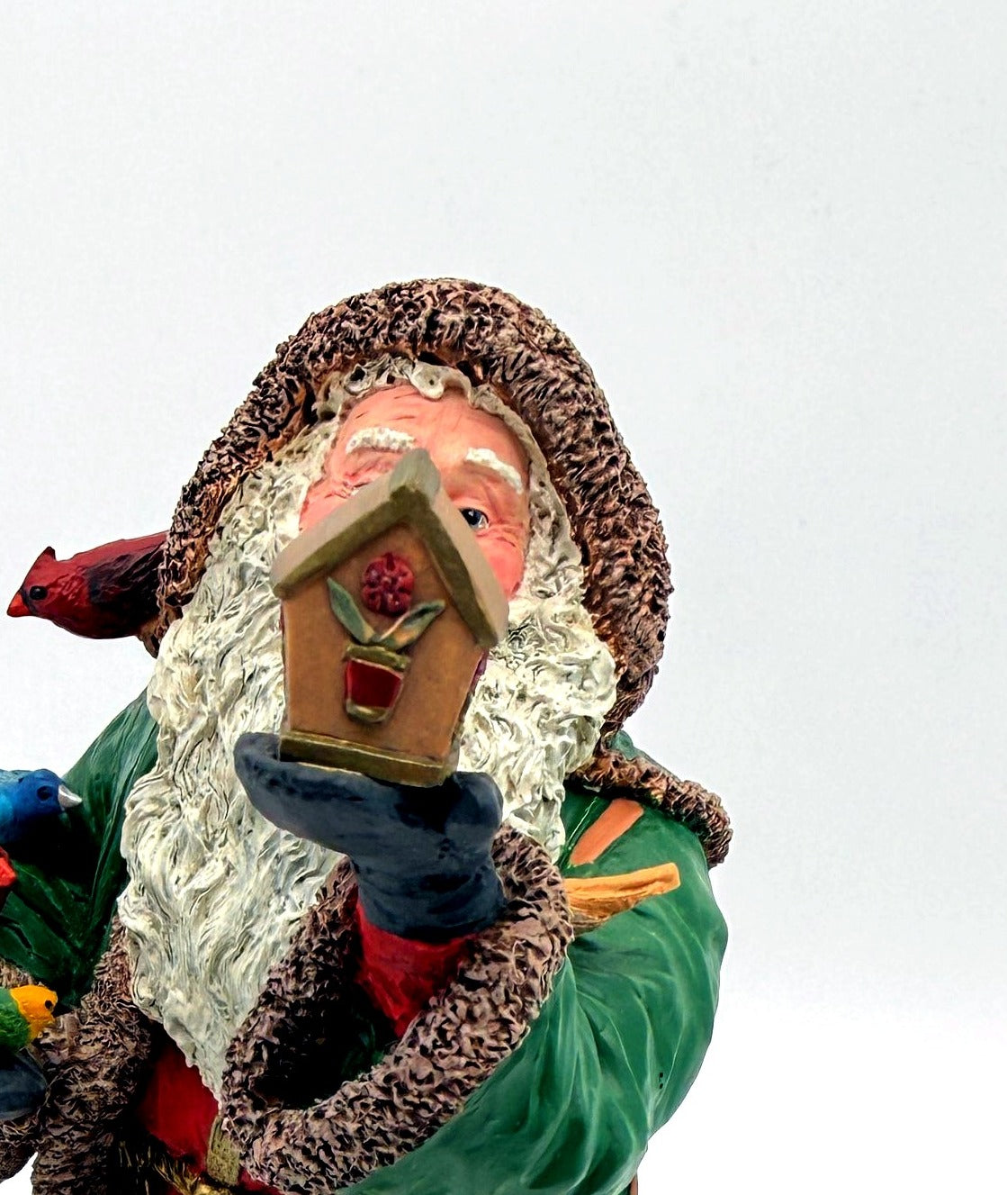 Detail: sculpted birdhouse held in Santa's hand (detail from seller photo)