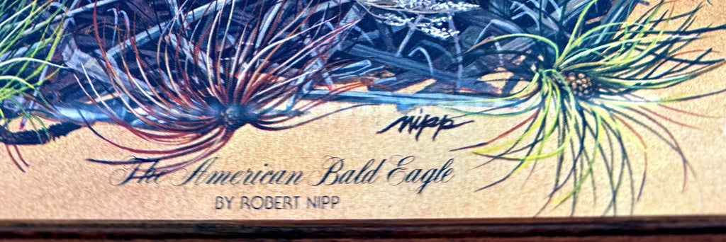 Close-up detail crop — the printed caption 'The American Bald Eagle – By Robert Nipp' and the printed Nipp signature