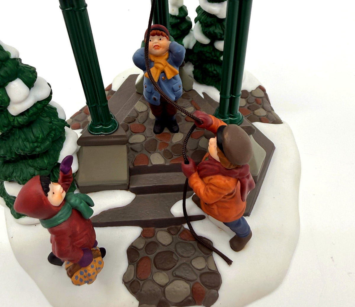 Department 56 Christmas Bells, 1996 Special Event Piece, Heritage Village Collection – detail: the three children ringing the bell, cobblestone path