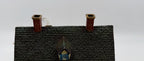 Close-up of the shingled roof, dormer, and brick chimneys