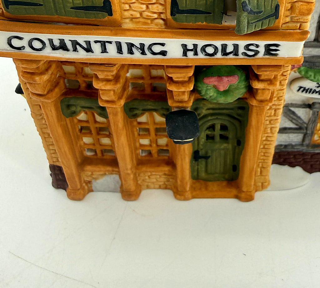 Detail of the Counting House sign, Christmas wreath and green front door