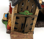 Department 56 Dickens' Village Butter Tub Barn #58338 – detail: wooden double doors with black hinges and holly swag on the stone front