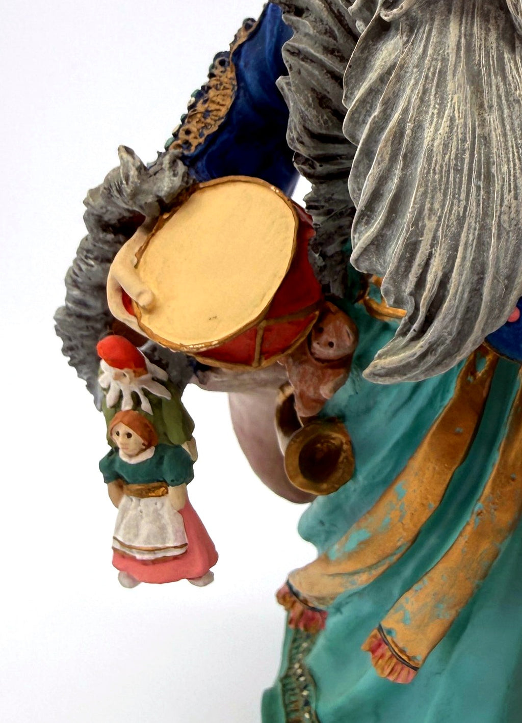 Detail: toy drum, two small dolls and brass horn (detail from seller photo)