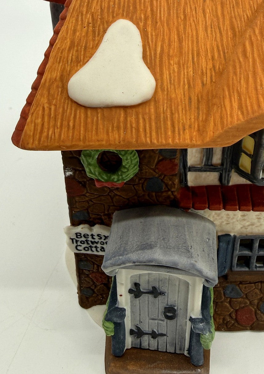 Department 56 Dickens' Village Betsy Trotwood's Cottage #5550-6, David Copperfield — detail: covered porch, Betsy Trotwood's Cottage sign, and wreath