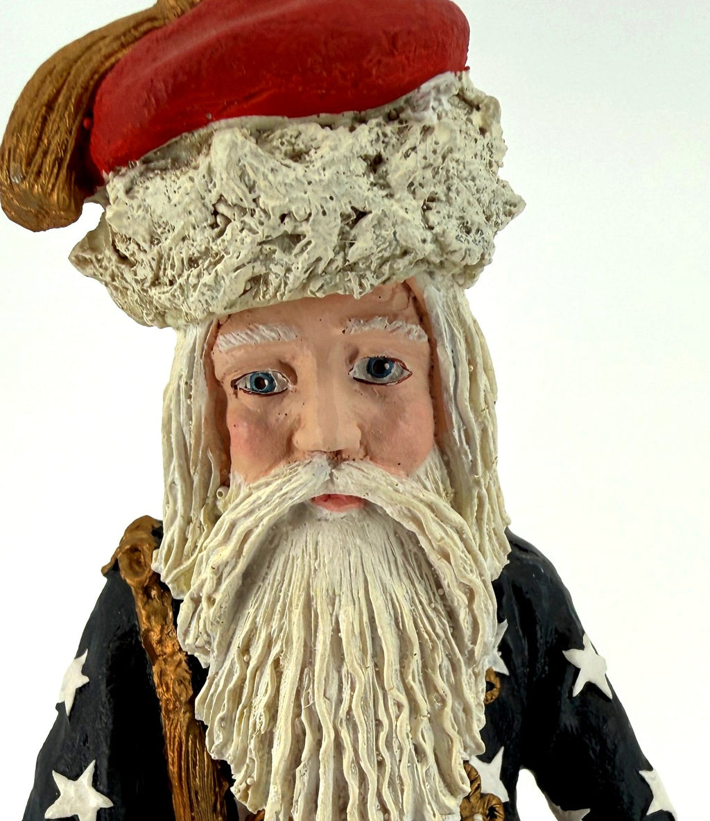 Detail close-up — the Civil War Santa's hand-painted face, blue eyes, red cap with textured fur band and long white beard