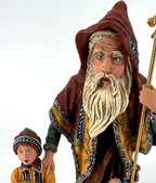 Detail close-up — the Star Man's hand-painted face and long white beard, with the child's face beside him