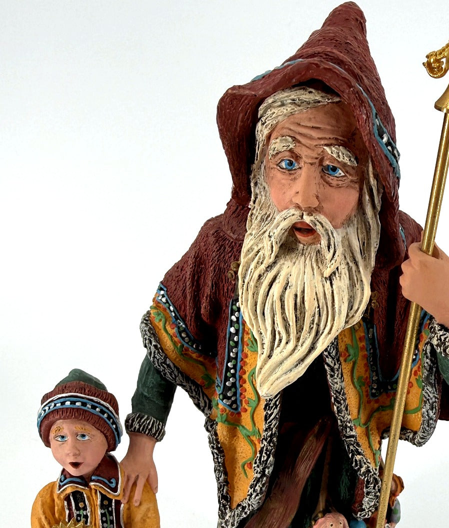 Detail close-up — the Star Man's hand-painted face and long white beard, with the child's face beside him