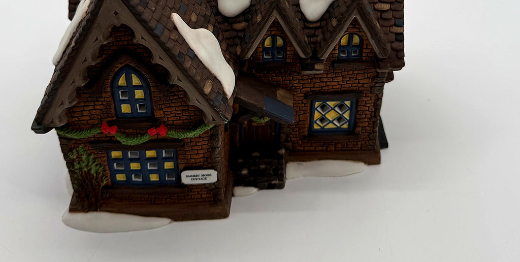 Detail of the evergreen garland, red bows and Barmby Moor Cottage name plaque