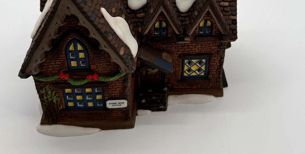 Detail of the evergreen garland, red bows and Barmby Moor Cottage name plaque