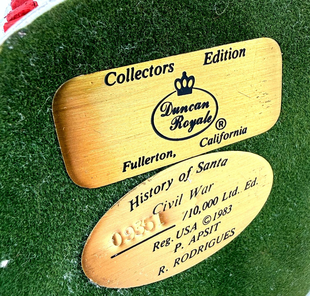 Detail close-up — underside plaques: Duncan Royale Collectors Edition, Fullerton California, and History of Santa – Civil War – 0931 /10,000 Ltd. Ed. – Reg. USA 1983 – P. Apsit – R. Rodrigues on the green felt base