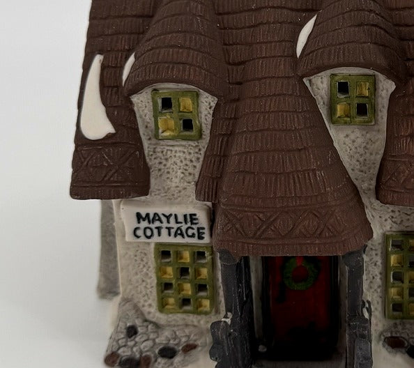 Department 56 Dickens' Village Maylie Cottage #5553-0, Oliver Twist — detail: covered porch, Maylie Cottage sign, and the wreath on the door