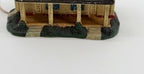 Close-up of the covered front porch, posts, and front door