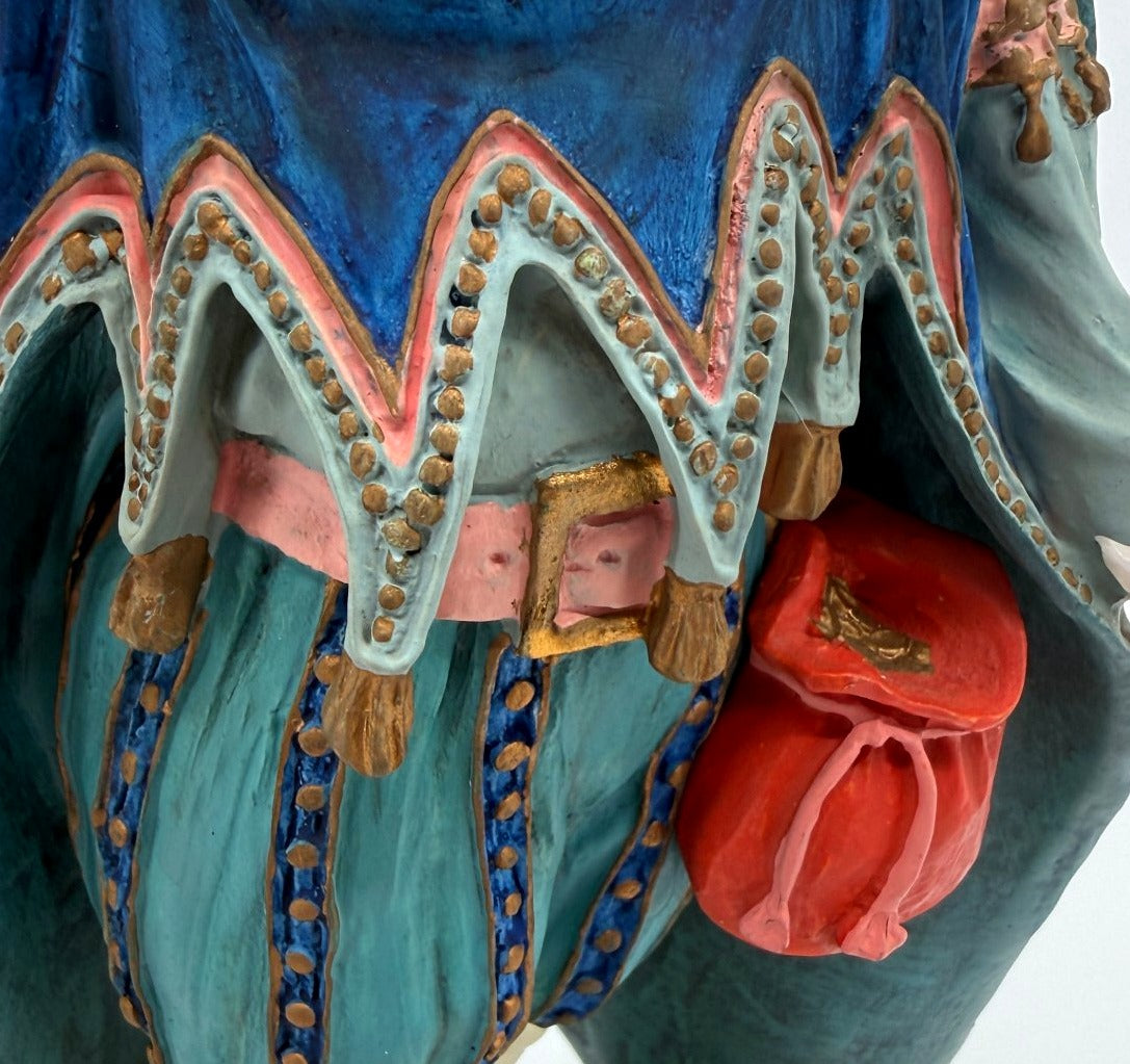 Vintage 1985 Duncan Royale Sir Christmas figurine – detail of the red drawstring pouch, pink sash with gold buckle, and scalloped cape trim with gold dots