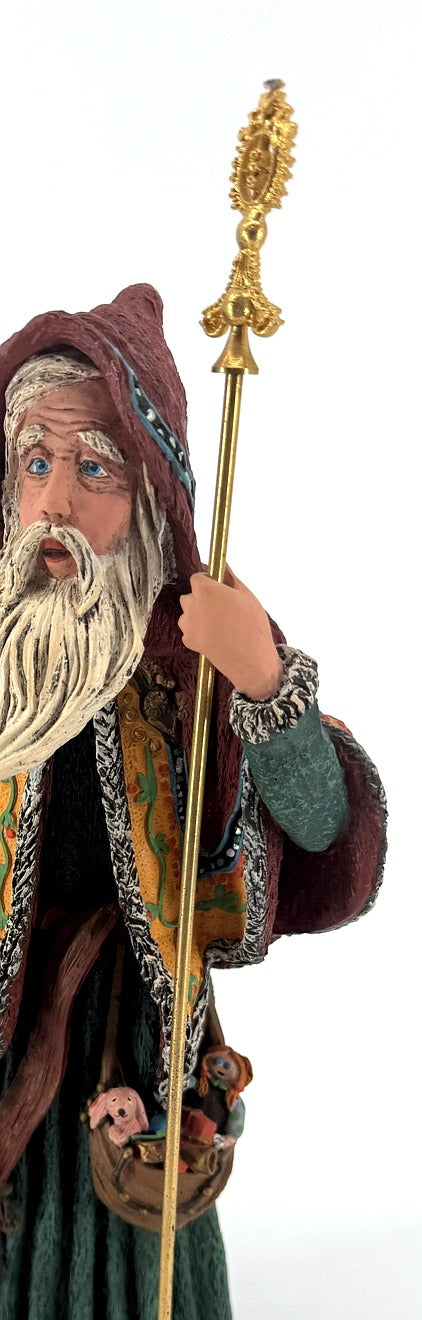 Detail close-up — the ornate gold staff head and the pouch of miniature toys at the Star Man's waist