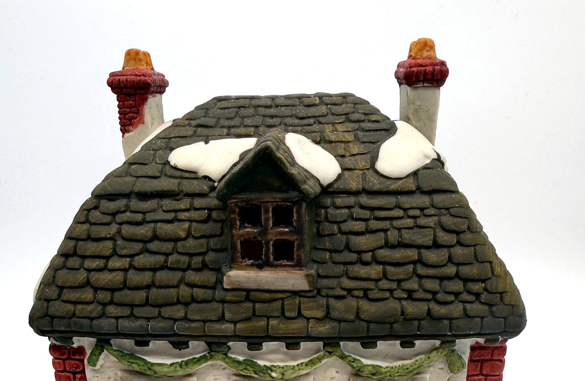 Department 56 M. Fezziwig Warehouse, Dickens' Village, 1986 – detail: sculpted slate roof, dormer, chimneys and green garland swag