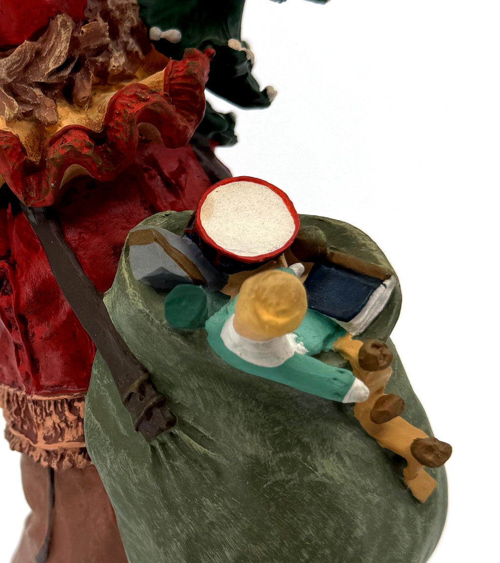 Detail: green toy sack with miniature drum, doll and toys (detail from seller photo)