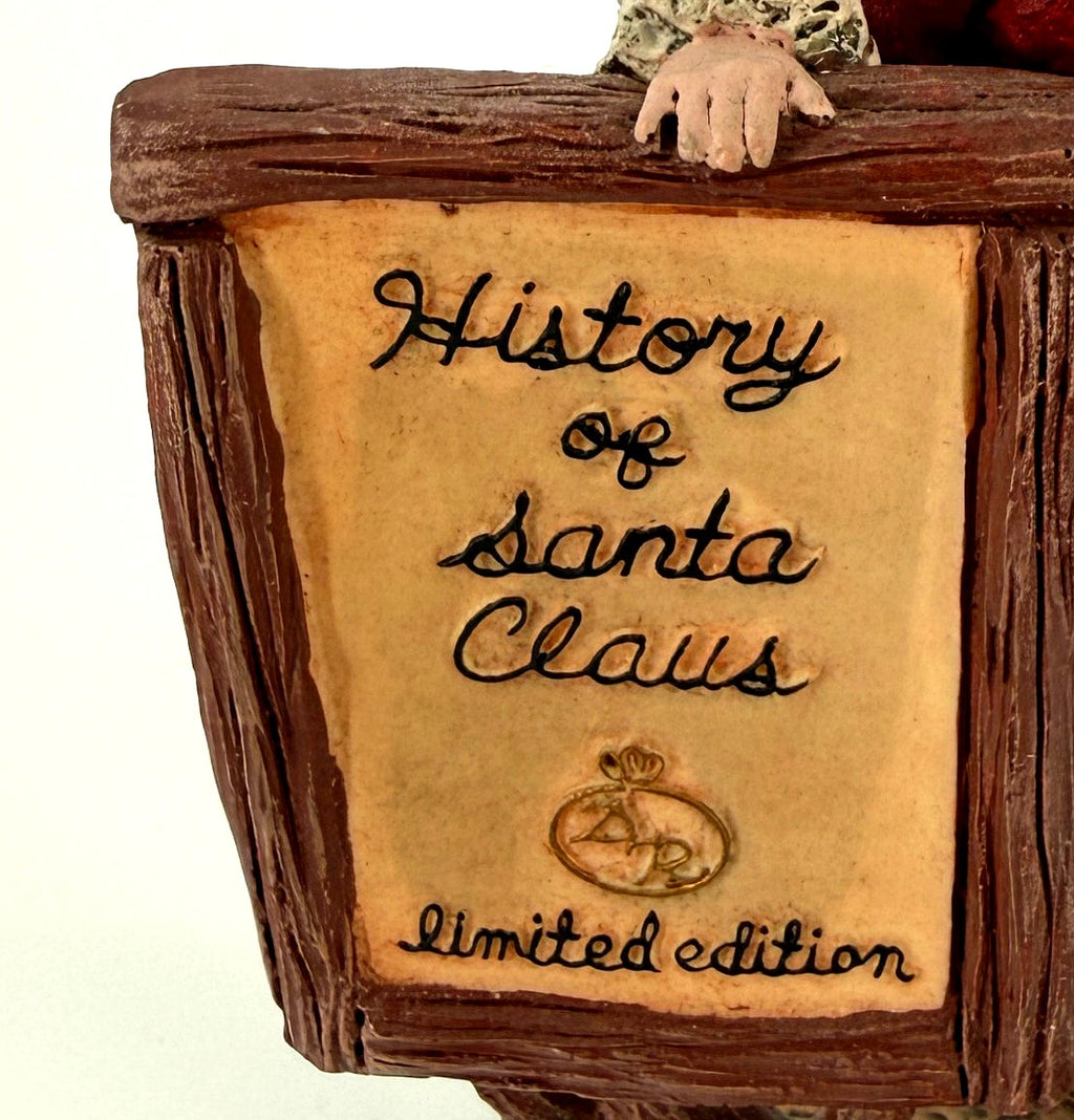 Close-up detail of the dimensional sign lettering — History of Santa Claus with the Duncan Royale emblem and Limited Edition, the helper's hand resting on the top rail