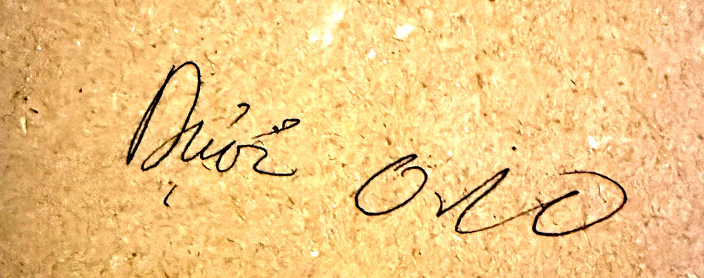 Close-up detail crop — the artist's handwritten signature on the backing board